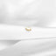 a close up of a piece of jewelry on a white cloth