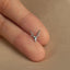 a person's hand holding a tiny deer head ring
