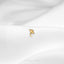 a close up of a gold ring on a white cloth