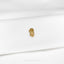 a close up of a gold brooch on a white shirt
