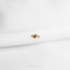 a close up of a gold ring on a white cloth