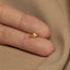 a person's hand with a gold ring on it