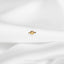 a small gold ring on a white cloth