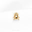 a gold beetle brooch sitting on top of a white surface