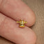 a person's finger with a small gold animal ring on it