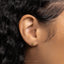 a close up of a person's ear with a gold earring