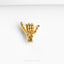a gold brooch depicting a hand holding a heart