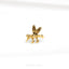 a gold bee brooch sitting on top of a white surface