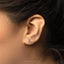 a close up of a person's ear wearing a pair of earrings