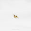 a gold kangaroo brooch sits on a white surface