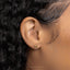 a close up of a person's ear with a gold earring