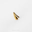a gold ring on a white surface