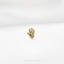a close up of a gold brooch on a white cloth