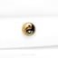 a black and gold button on a white cloth