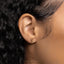 a close up of a person's ear with a gold earring