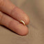 a person's finger with a gold ring on it