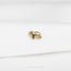 a small gold dog pin sitting on top of a white sheet