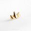 a close up of a gold ring on a white surface