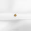 a small gold star on a white cloth