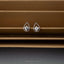 a pair of diamond earrings sitting on top of a window sill
