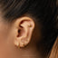 a close up of a person wearing a pair of ear piercings