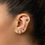 a woman&#39;s ear with a nose piercing