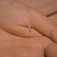 a person&#39;s hand with a tiny diamond ring on it