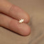 a person&#39;s finger with a tiny gold puzzle piece on it