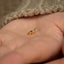 a tiny gold bird ring sitting on someone&#39;s hand