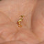 a close up of a person&#39;s hand with a small gold bird on it