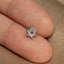 a person&#39;s finger with a small star of david pin on it