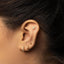 a close up of a person wearing a pair of ear piercings