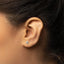 a close up of a person wearing a pair of ear piercings