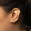 a close up of a person wearing a pair of ear piercings