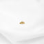 a pair of earrings sitting on top of a white sheet