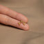 a person's hand with a gold ring on it