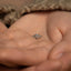a person holding a tiny ring in their hands