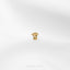 a gold ring on a white surface