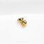 a close up of a gold brooch on a white surface