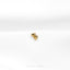 a pair of gold earrings sitting on top of a white surface