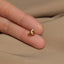 a person&#39;s hand with a gold ring on it