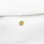a close up of a gold plated object on a white surface