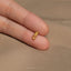 a person&#39;s finger with a gold ring on it