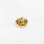 a gold pumpkin ring sitting on top of a white surface