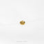 a pair of gold earrings sitting on top of a white sheet