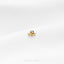 a small gold ring sitting on top of a white surface