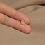 a person wearing a gold ring with a knot on it