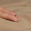 a person's hand with a ring on it