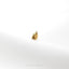 a gold ring sitting on top of a white surface