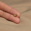 a person's hand with a gold ring on it